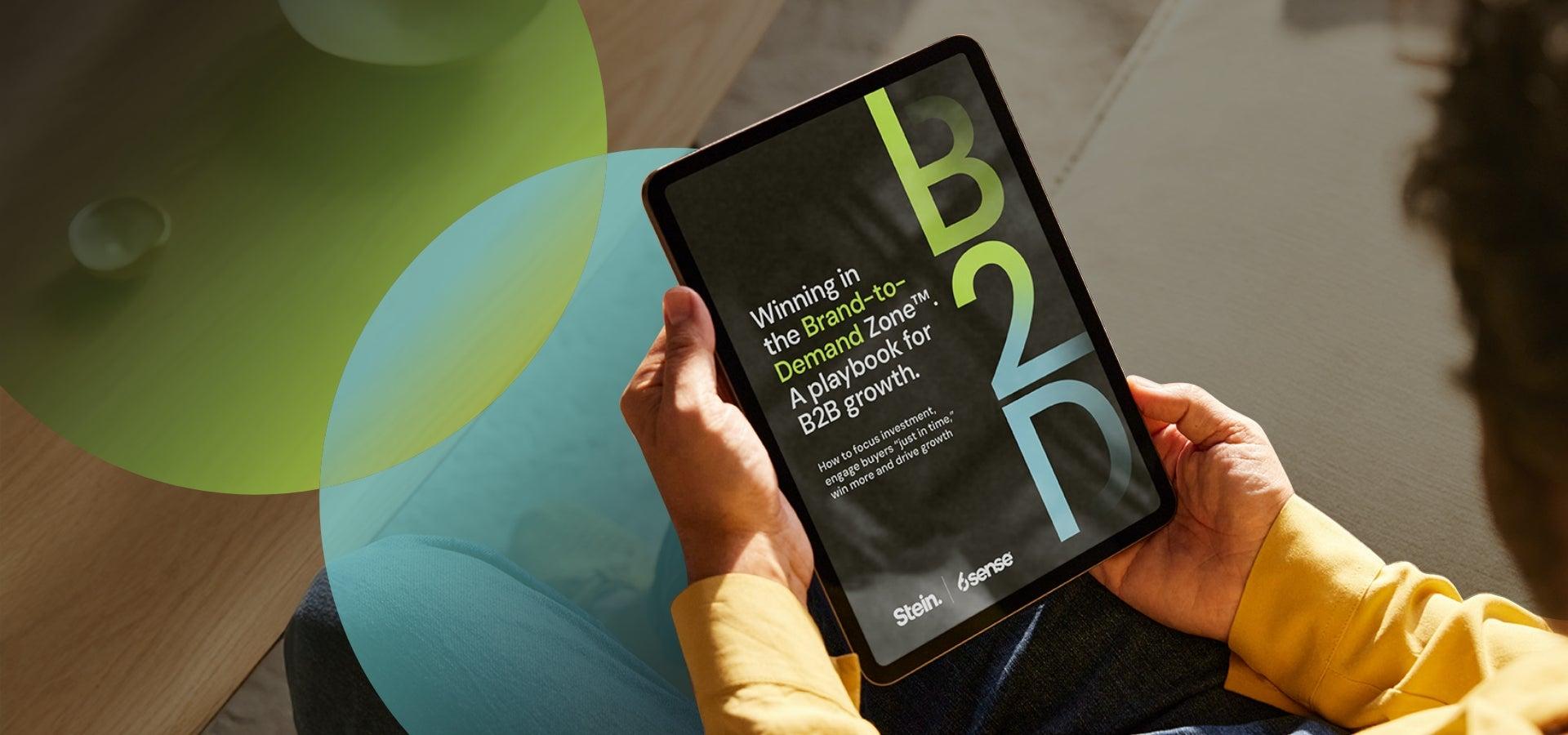 Someone holding an iPad with the cover of a playbook on it.