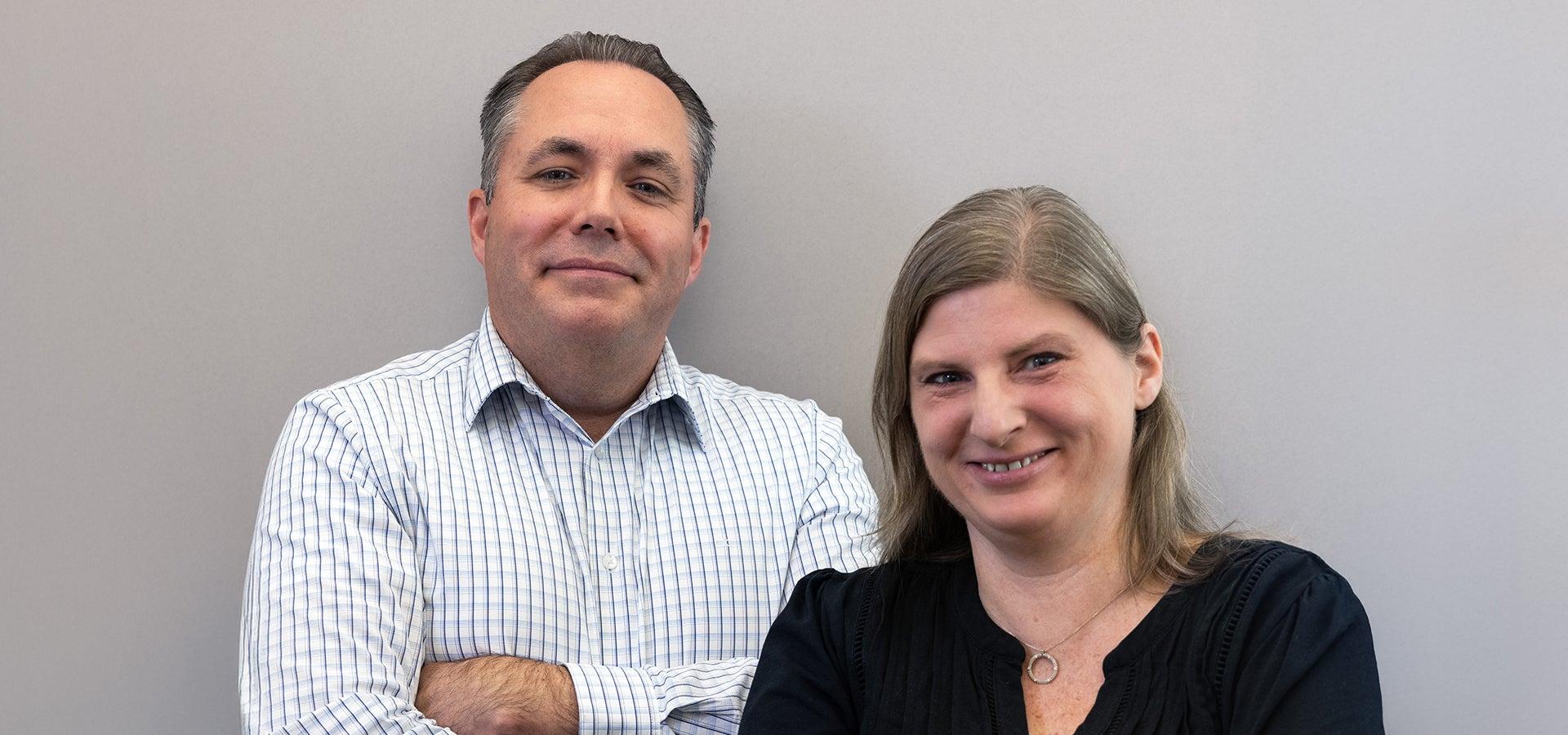 Two people posing for a still headshot